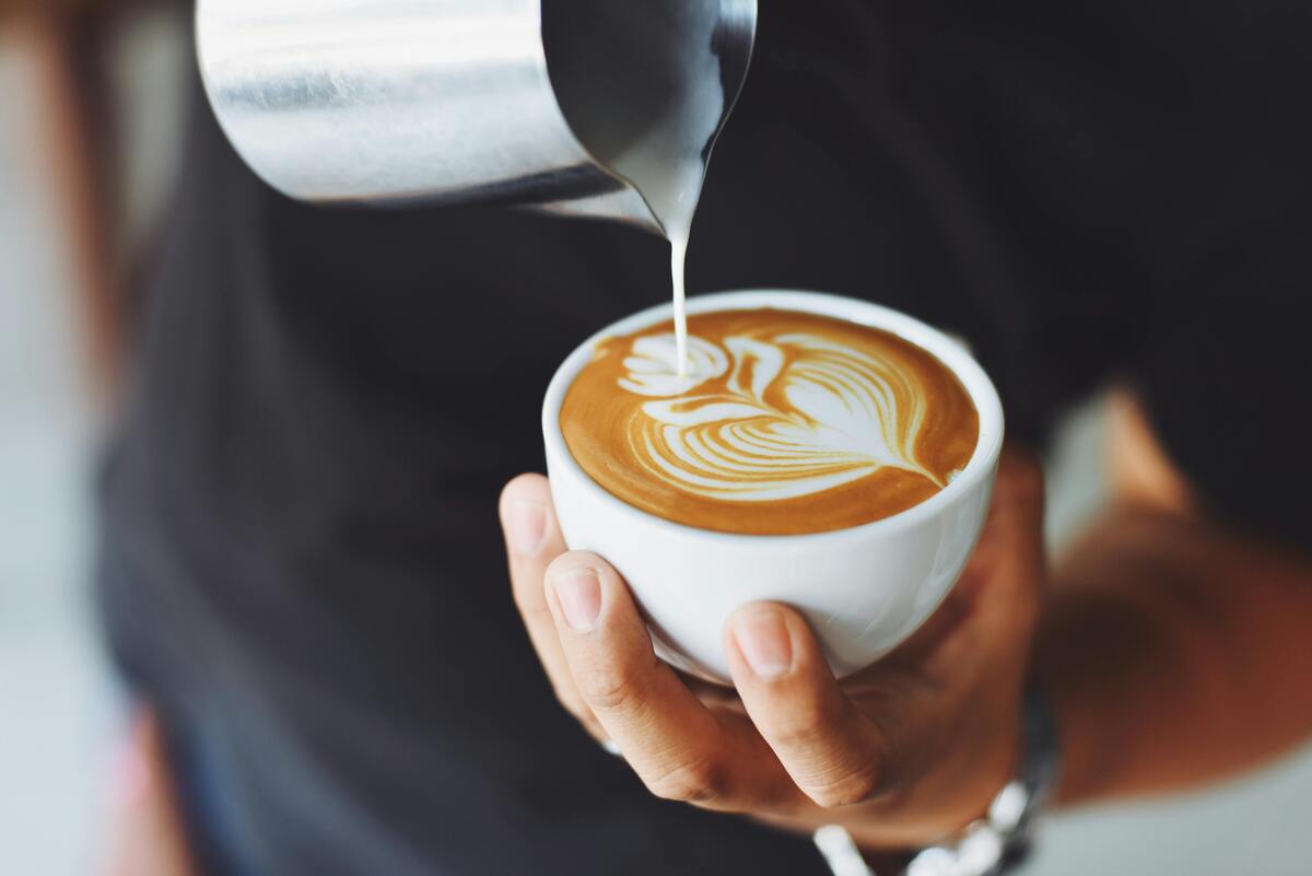 Barista pouring latte art at SnowMoon